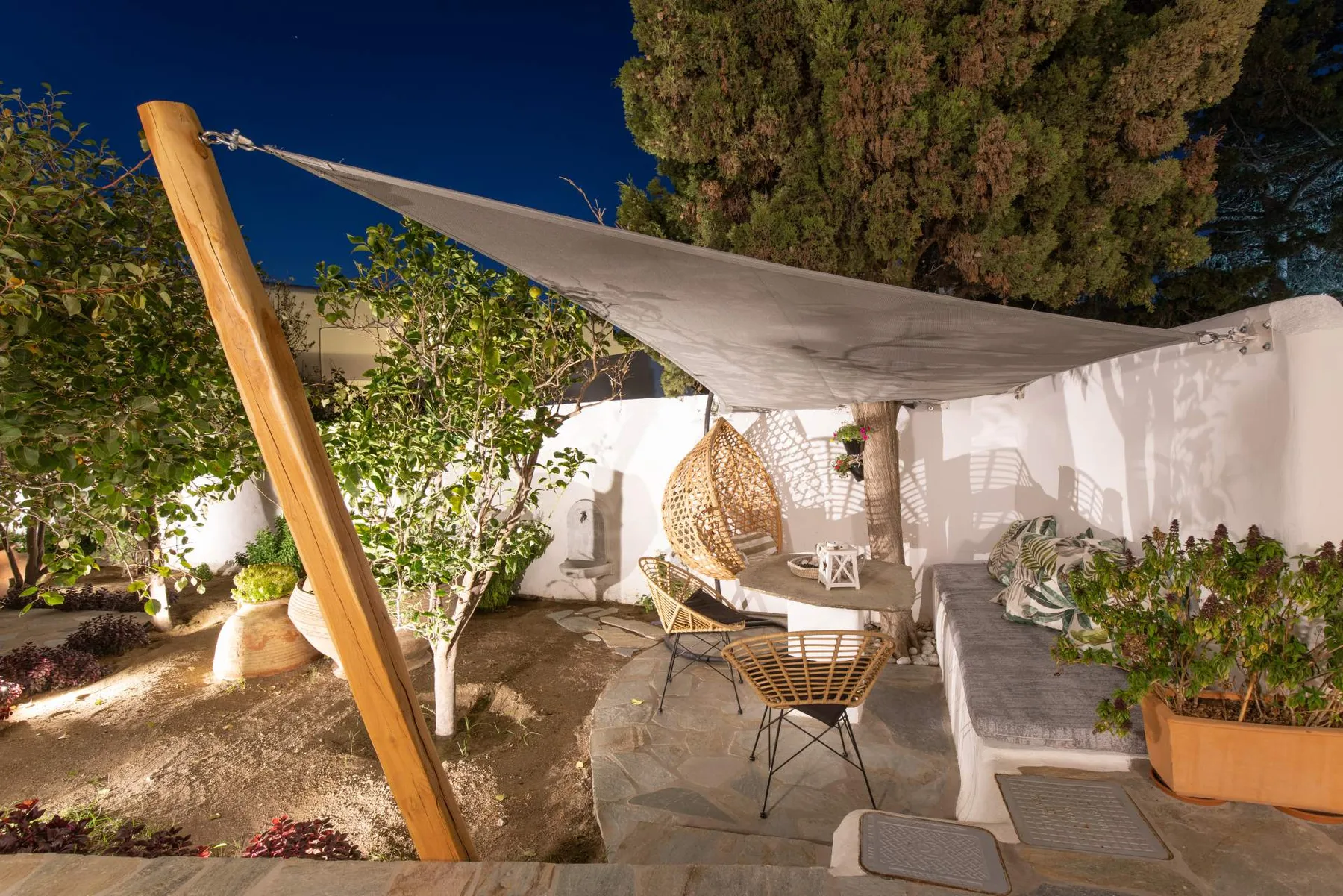 Hanging chair beneath the trees in the evening